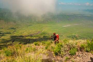 Fototapeta premium A hiker against a mountain background at Mount Ol Doinyo Lengai in Tanzania 