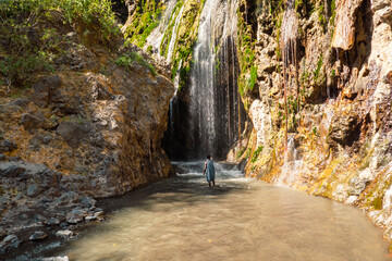 A masai man at Nagre Sero Waterfall in Ngare Sero Hiking trail in Tanzania