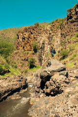 A masai man at Nagre Sero Waterfall in Ngare Sero Hiking trail in Tanzania