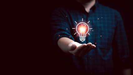 Businessman holding glowing lightbulb drawing with copy space for creative thinking idea and...