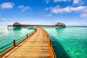Maldives paradise island. Tropical aerial landscape, seascape long jetty pier water villas. Amazing sea sky sunny lagoon beach, tropical nature. Exotic tourism destination popular summer vacation
