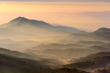 Mountain range with in sunrise sky, mountain ridge view from Doi Inthanon mountain peak with sunrise light, Chiangmai Thailand.