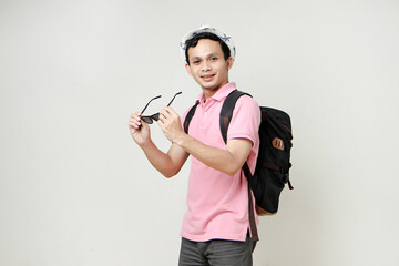 Asian man backpacker wearing sunglasses and hat. digital nomad and travelling concept. on isolated background