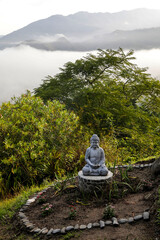 Foggy landscape and buddha statue in Vilcabamba, Ecuador