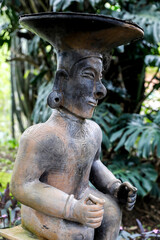 Fototapeta na wymiar Balinese statue in a garden in Vilcabamba, Ecuador