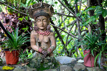 Fototapeta na wymiar Balinese statue in a garden in Vilcabamba, Ecuador