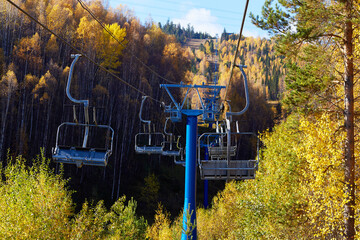 Chairlift to the top of the mountain. Beautiful autumn landscape. 