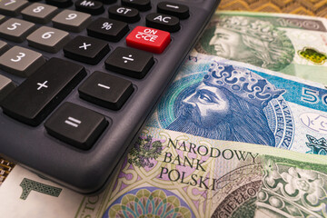 Close up on Polish Złoty banknote with calculator economic crisis concept new year price increase...