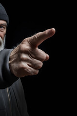 Man with beard pointing at something with his finger.