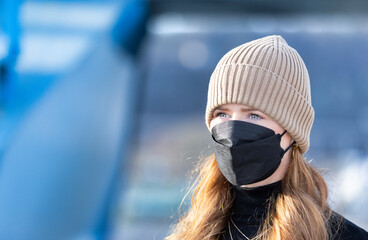 Woman with red long hair, blue eyes, young with FFP2 mask, wearing beige cap and black sweater, head portraits