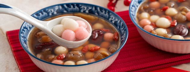 Homemade red and white tangyuan with syrup soup, dried longan pulp, red dates for Winter solstice.