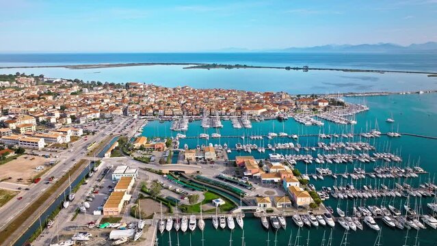 Aerial view of D-Marin Lefkas Marina full of boats and ships in Lefkada. The island's capital and port town with turquoise waters, Greek-style houses with colourful shutters, and wooden balconies.