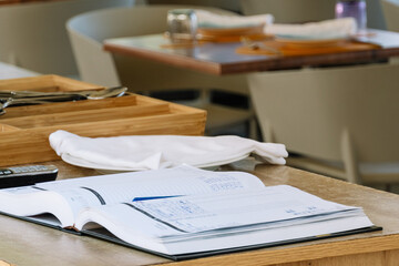 A close-up of a reservation diary from a traditional restaurant with the background out of focus.