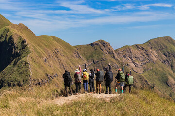 Group of hiking or hiker people stand in mountains and looking the target to go mountain peak at Khao Chang Phuak in Thong Phum National Park, Thailand.