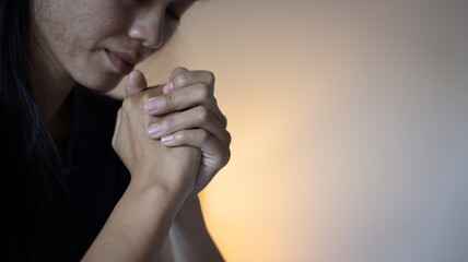 Hands folded in prayer concept for faith, Religious young woman praying to God in the morning,...