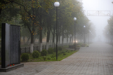 Cityscape. Alley during fog in the early morning in autumn.