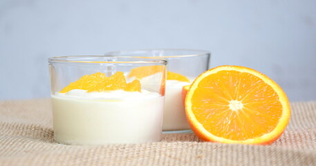 Orange cream, dessert, delicious fruity cream with oranges in a glass, isolated, dessert winter	