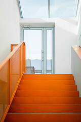 Orange steps into the office interior lead to the terrace. Part of the interior of a modern comfortable office.