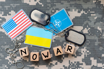 Military patch and bullets on pixel Ukrainian camouflage, closeup no war