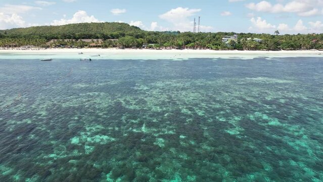 Aerial - Passing by tourist outrigger boat moored near Dumaluan Beach during a weekday in the island of Panglao, Philippines.