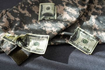 American dollars banknotes on military pixel background.