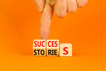 Success stories symbol. Turned wooden cubes and changed the word stories to success. Beautiful...