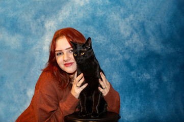 Young woman with her black cat