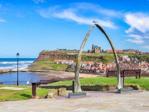 The historic whalebone arch on West Cliff, Whitby, North Yorkshire, framing the view of Whitby Abbey.