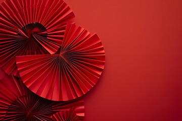 Chinese new year festival or wedding decoration over red background. Traditional lunar new year paper fans. Flat lay, top view, banner