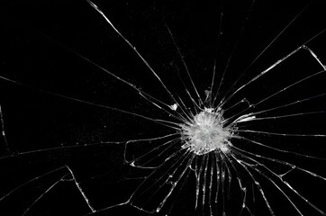 Photo of broken glass on a black background, cracks.