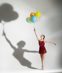 Ballet dancer posing with ballons