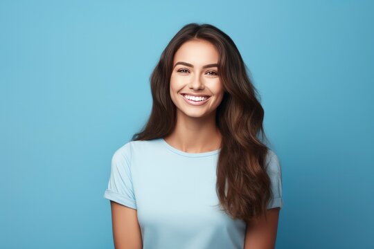 Photo of attractive brunette young woman wearing casual clothes standing isolated over blue background