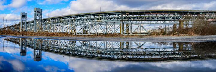 Gold Star Memorial Bridge in New London, Connecticut, the arching landmark suspending bridge over the Thames River, reflected symmetrical shapes over the water