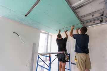 Fototapeta na wymiar Construction worker ceiling work installation