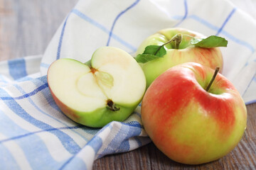 Red and green apples with leaves