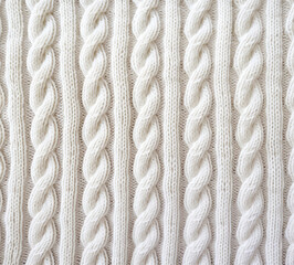 Knitting with white yarn, background.