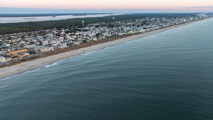 Early morning aerial view of Kure Beach town, with residential streets paralleling the quiet beachfront in North Carolina.