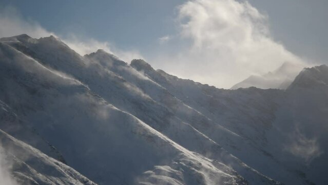 stunning view of mountain peaks sun, mist passing by