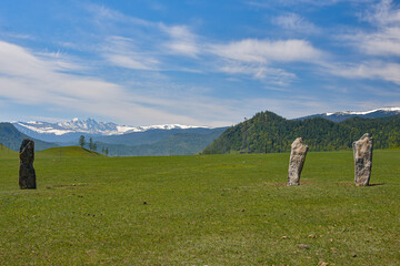 Pillars of stones in the field. Bright sunny day in the mountains.