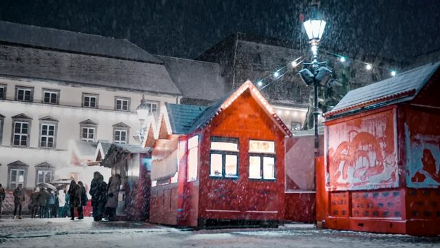 Slowmotion of Christmas market, where people in big city enjoy enchanting Christmas season with snowfall. Germany