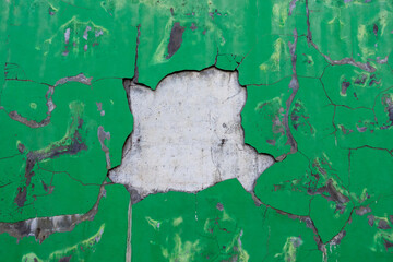Old concrete wall with cracked flaking paint. Broken green wall abstract background