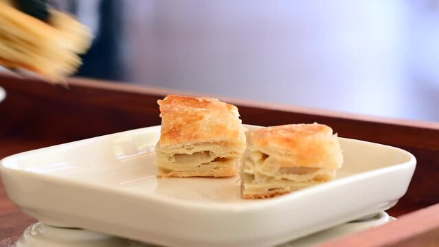 Chef puts Kurt pastry on a white porcelain plate