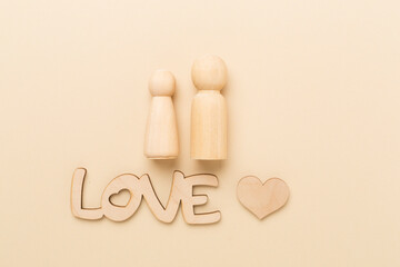Wooden couple in love on color background, top view. Creative valentine's day composition