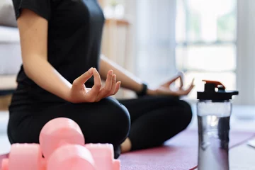 Foto op Plexiglas Young woman practicing lotus asana in yoga studio. Padmasana pose © itchaznong