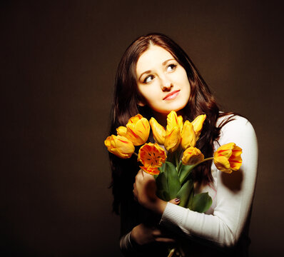 Happy brunette  woman with tulips