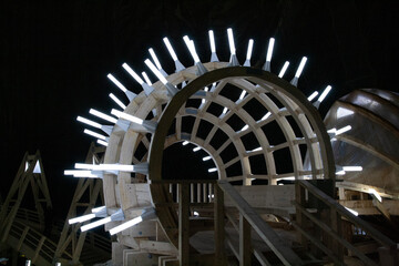 A mesmerizing sculpture created from intertwined wooden sticks and illuminated by a captivating...