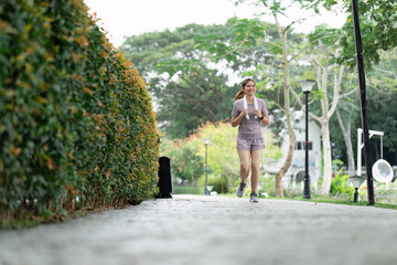 Fototapeta na wymiar Women runner wearing sport cloths jogging in morning at park. Active morning