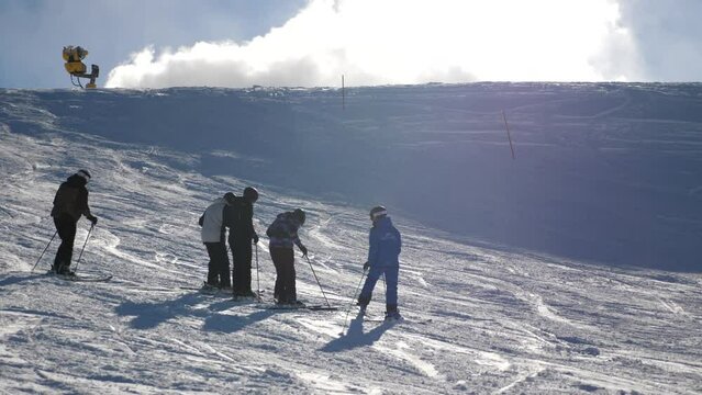 skiers on a ski resort, ski teacher explaining