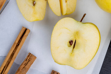 yellow ripe apple with cinnamon on the table