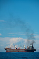 Rusty Red Cargo Ship on the Blue Ocean
